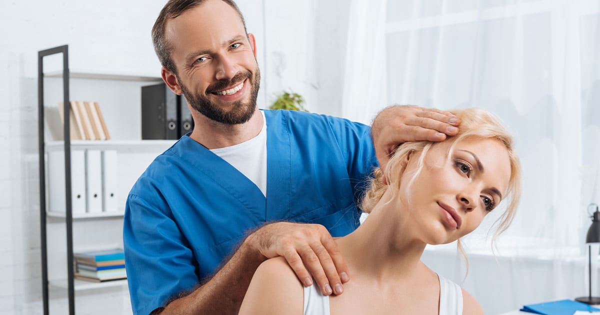 portrait of smiling chiropractor stretching neck