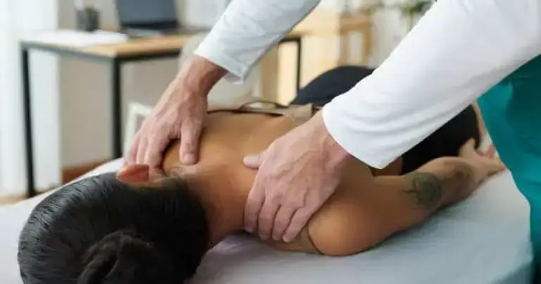 Chiropractic adjustment being performed on a patient to relieve back pain.