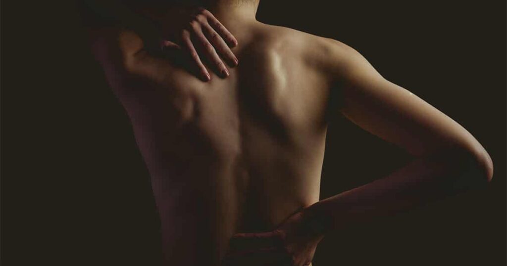 Person performing back stretch exercise for pain relief.